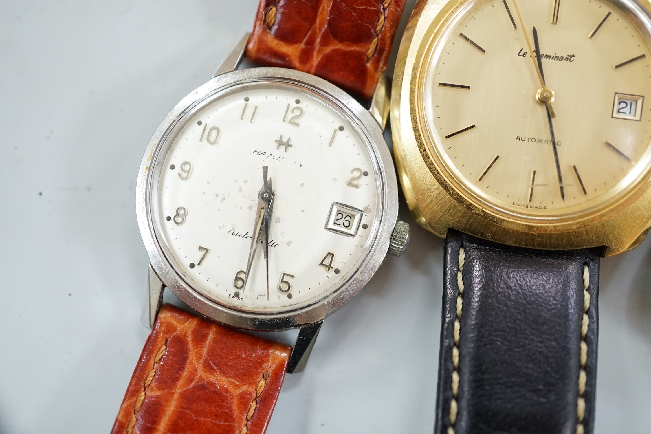 Three assorted gentleman's steel or gilt wrist watches, including retailed by Buhre and a lady's steel manual wind Bulova watch.